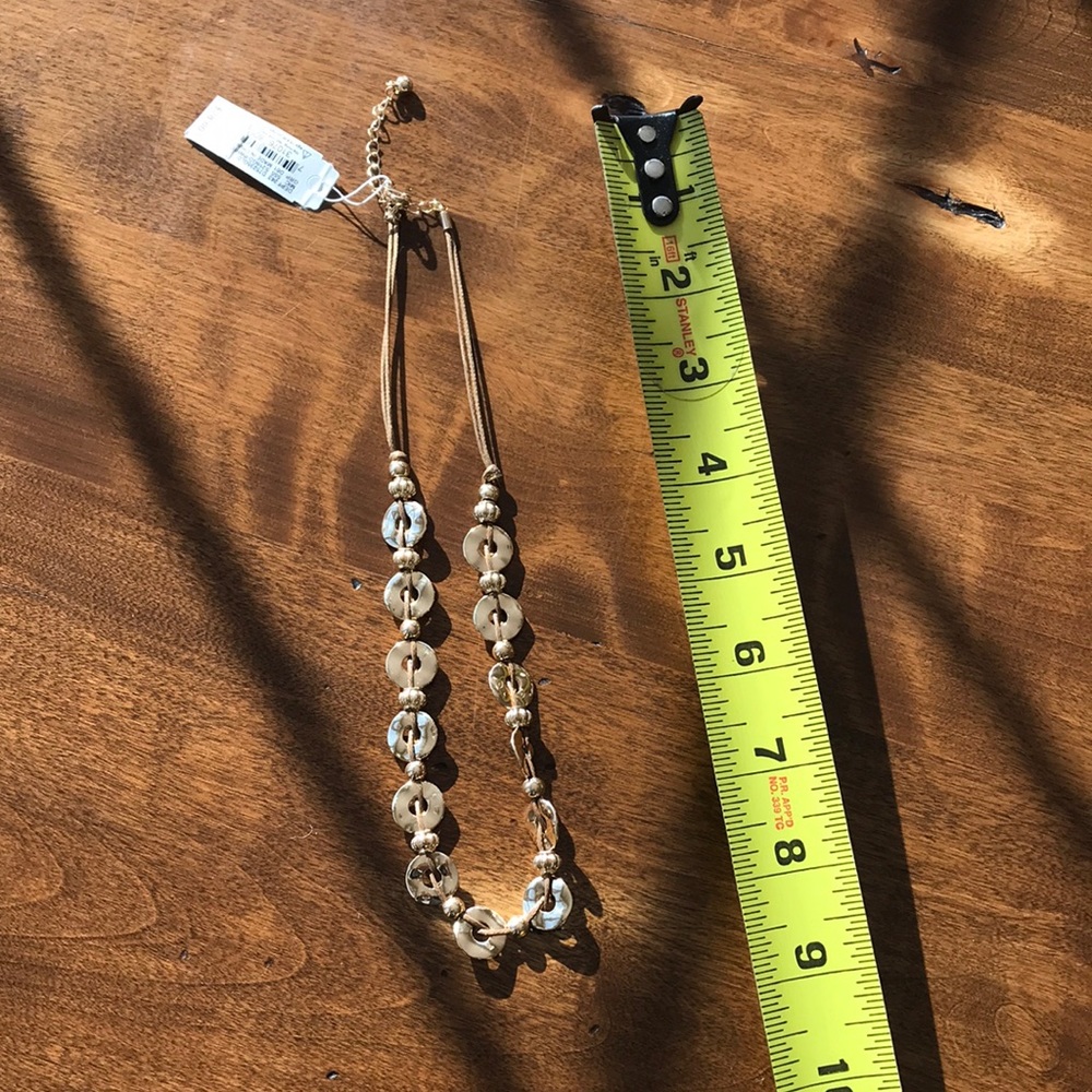 Gold tone and cord necklace.